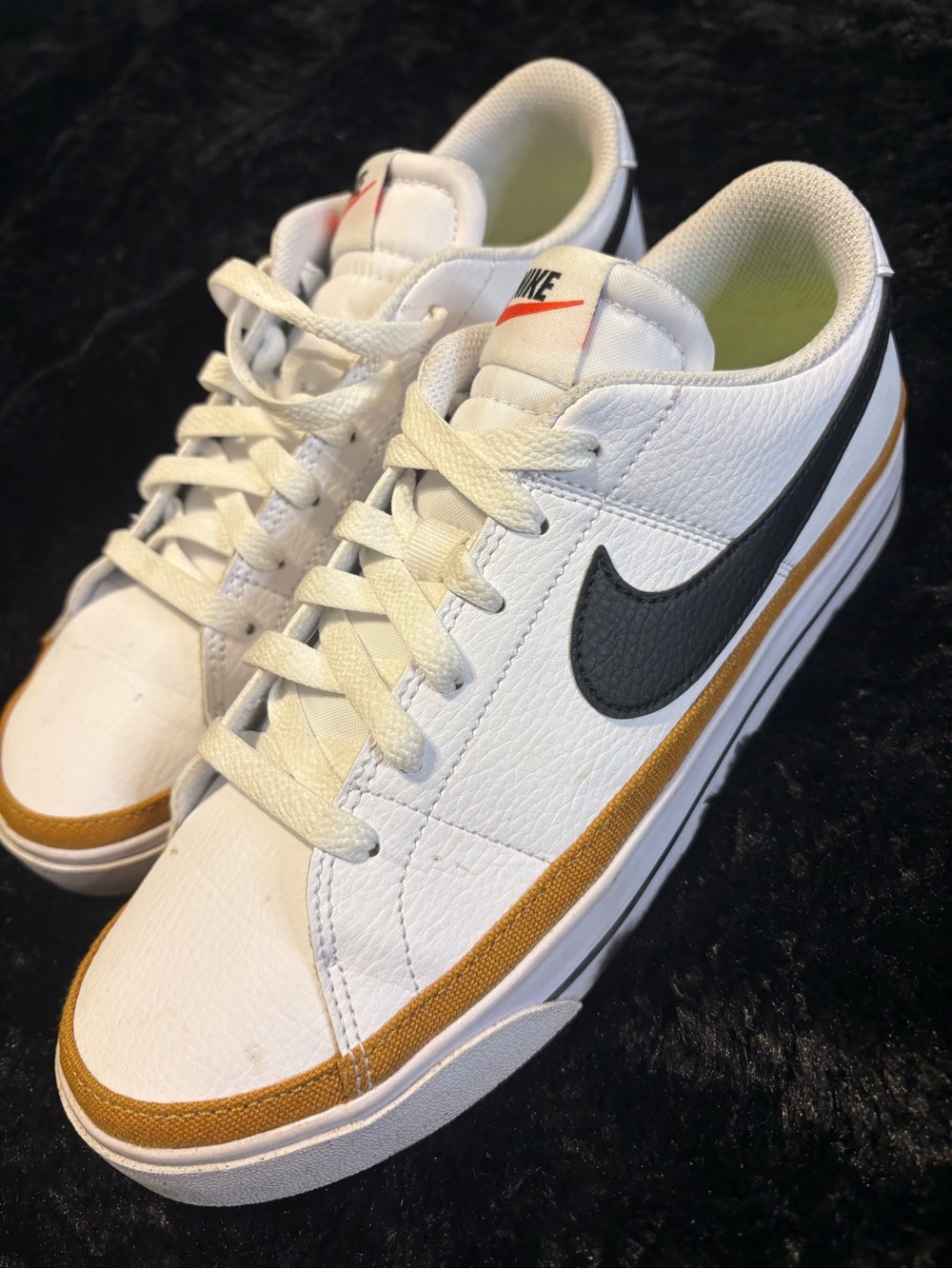 Nike womenβs White Sneakers with Black Swoosh and Gold Trim